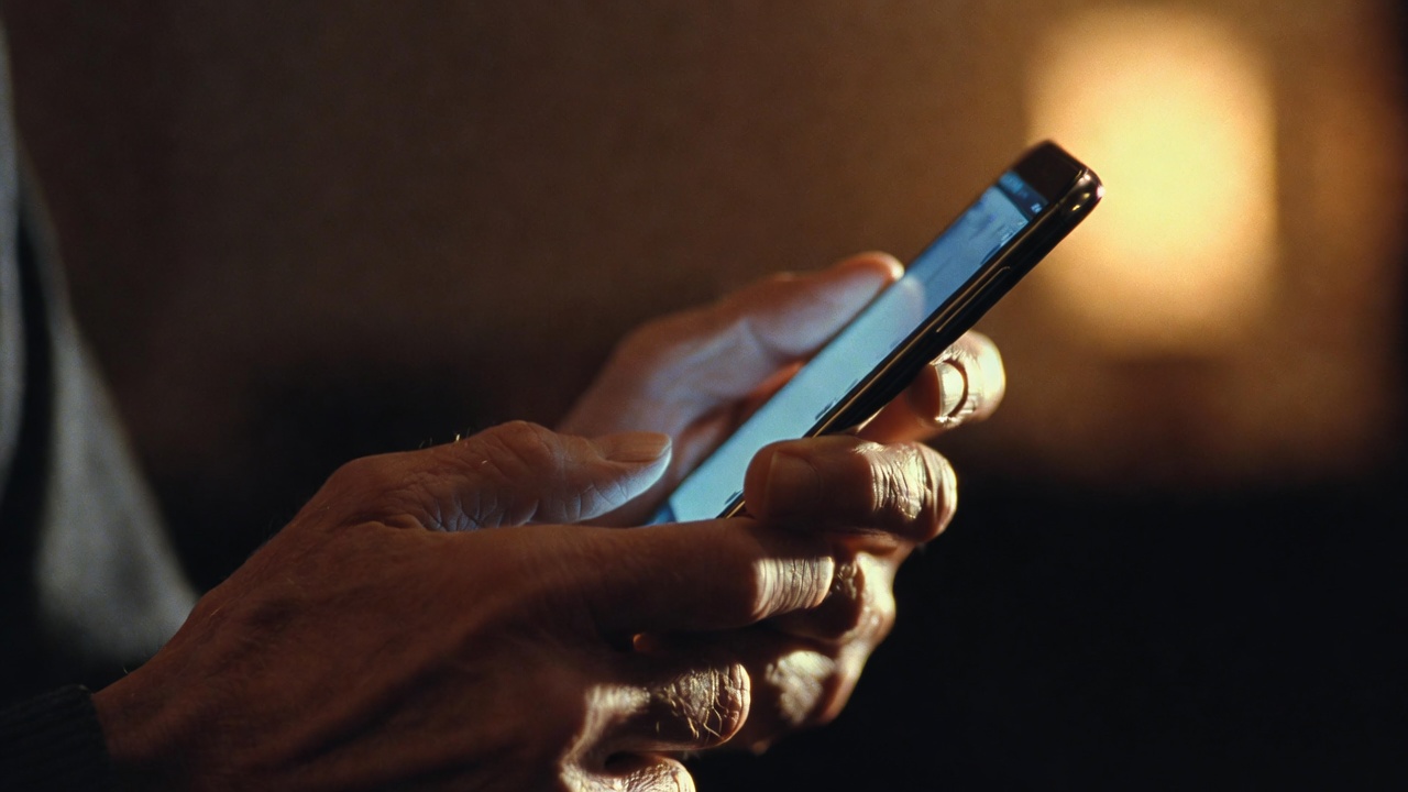 Elderly hands holding a smartphone